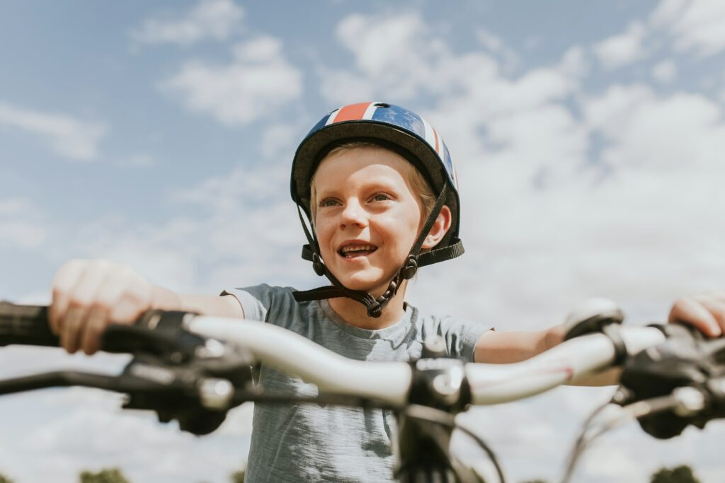 Kid’s hobby background, boy riding a bike, summer hobby